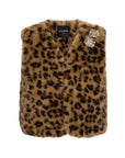 The Le Superbe Treasure Vest is a cropped faux fur vest featuring a brown and black leopard print and two jeweled brooches on the left shoulder.