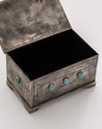 The J Alexander Rustic Silver 9 Stone Turq Box is a rectangular rustic silver box with an open lid, engraved patterns, and nine turquoise stones on the side, set on ornate feet—an ideal Southwestern decor accent shown against a white background.