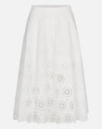 The FRAME Solstice Eyelet Skirt is a white, midi-length A-line with circular eyelet lace florals, a fitted waistband, and a gentle flare at the hem for a feminine silhouette.