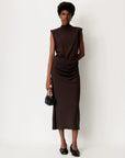 Brown DOLISH long skirt by Sessun styled with a black bag, shown against a plain white background.