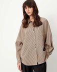 Sessun FONTANIA white button-up shirt with front pockets and long sleeves, shown with black pants.