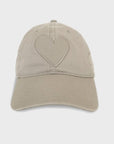 Introducing the KR Imperfect Heart Hat by Kerri Rosenthal—a beige 100% cotton baseball cap with a raised heart design, curved brim, and six-line stitching that contrasts beautifully against a plain white background; a must-have for collectors.