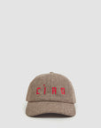 The Clare Vivier Wool CIAO Baseball Hat features a brown herringbone pattern, Peaky Blinders inspiration, and "CIAO" embroidered in red on the front, shown against a plain light background.