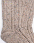 The Faire Wool Speckled Knit Socks are beige, cozy, and feature a ribbed cable-knit pattern with colorful specks in soft wool-blend fabric, shown laid flat on a white background.