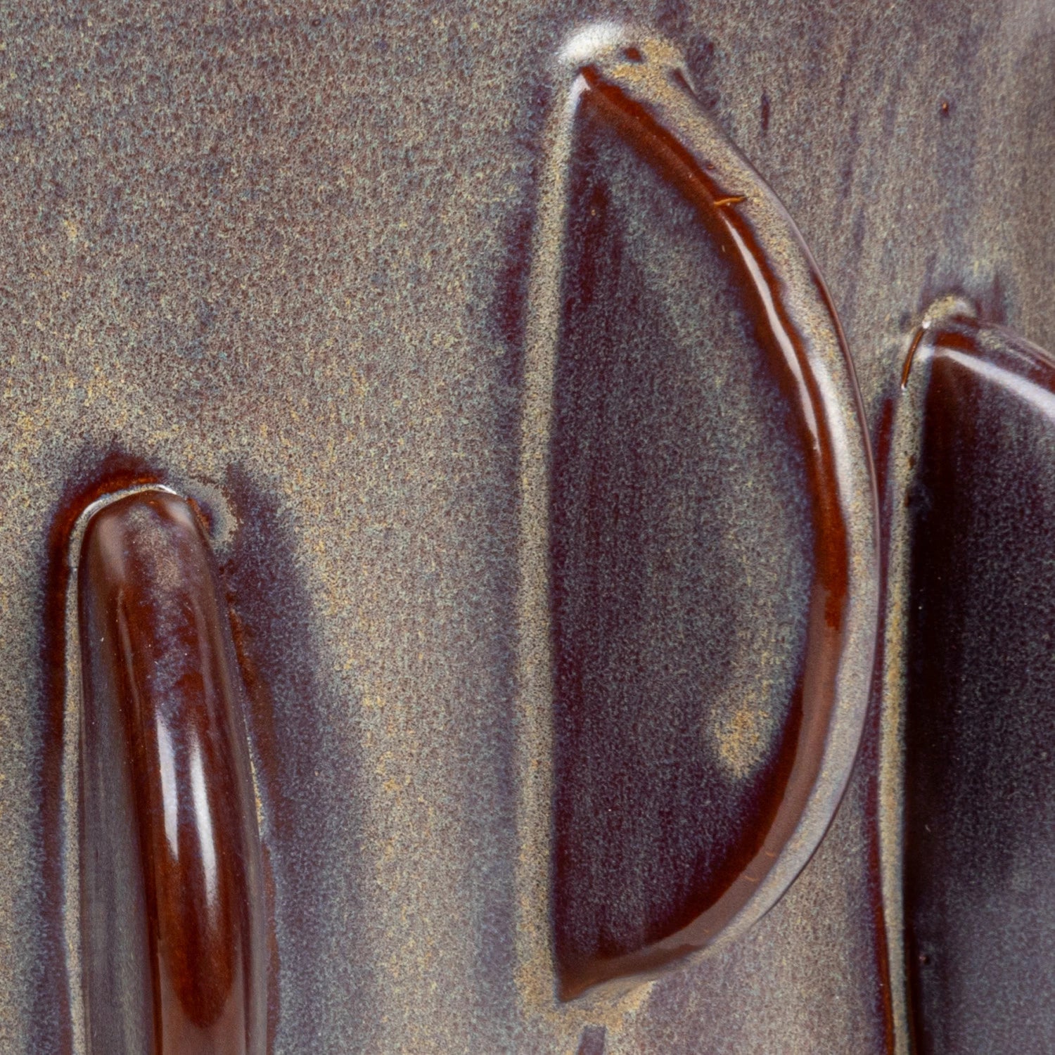Close-up image of a weathered metallic surface showing rust and distinct dark lines resembling abstract shapes, possibly part of a larger metal structure in Scottsdale, Arizona.