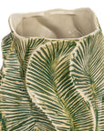 A close-up of the Bloomingville Green Floral Texture Vase, a round stoneware piece featuring green and cream palm leaf patterns and a wavy rectangular rim.
