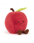 The Amuseables Apple by Jelly Cat Inc. is a plush red toy with a smiling face, brown stem, green leaf, and brown arms and legs, shown sitting upright against a white background.