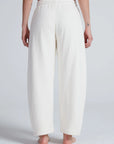 White high-waisted ASKK Cancun sweatpants in 100 cotton, barrel fit with elastic waist, shown from the back.