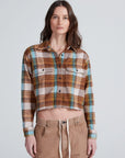ASKK Crosby Les Plaid flannel shirt, cropped fit, paired with beige pants, neutral backdrop, casual style.