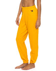 A person wears Aviator Nation logo women's sweatpants in bright yellow, featuring an embroidered "N" near the waistband, shown barefoot from mid-torso down against a plain white background for a vintage-inspired look.