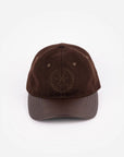 The Faire Aven Leather Ball Cap features a curved brim, subtle crossed golf clubs and laurel wreath embroidery, and an adjustable strap—an ideal winter accessory shown against a plain white background.
