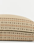 The Jacob Woven 22x22 Pillow by Faire features a beige cotton cover, handwoven in Gujarat, India, with a geometric brown and tan pattern and a gold zipper, shown partially open against a plain white background.
