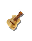 The Faire Fashion Hair Clip is a small, decorative accessory shaped like a guitar, made from eco-friendly cellulose acetate with a cream body, brown neck, and three star cutouts. Shown on a white background with a gray shadow.