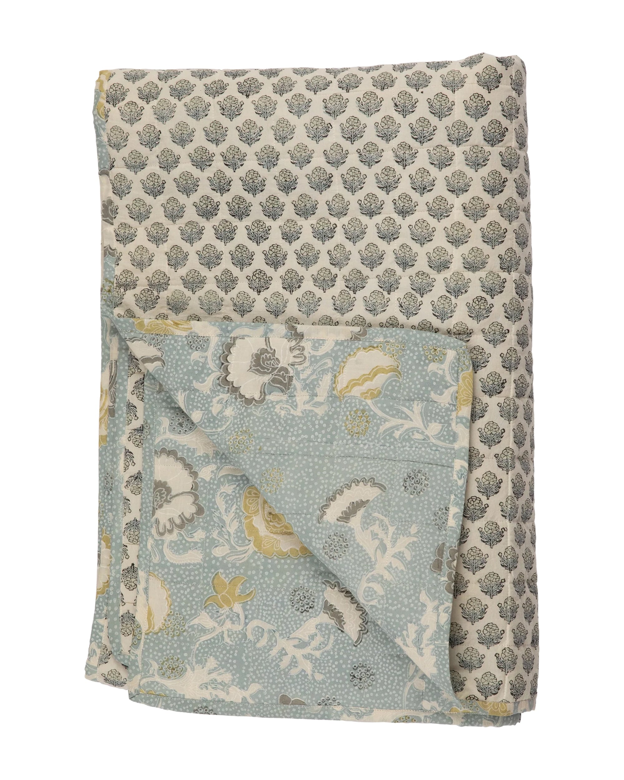 The Bailey Tulip Azur Coverlet 80x100 by Filling Spaces LLC is a 100% cotton folded quilt with intricate quilting, gray and white leafy patterns on one side, and blue with white, yellow, and gray floral designs on the other.