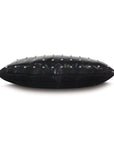 The Eastern Accents NAILHEAD DECO pillow is a black rectangular faux leather accent with a shiny finish and evenly spaced silver nailhead details on top, shown from the side against a white background.