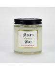 A clear glass jar with a black lid labeled "Bear's Cave" and "Austin Press SF," containing the white, all-natural Austin Press Travel Candle by Faire, made from botanical waxes, is shown against a plain white background.
