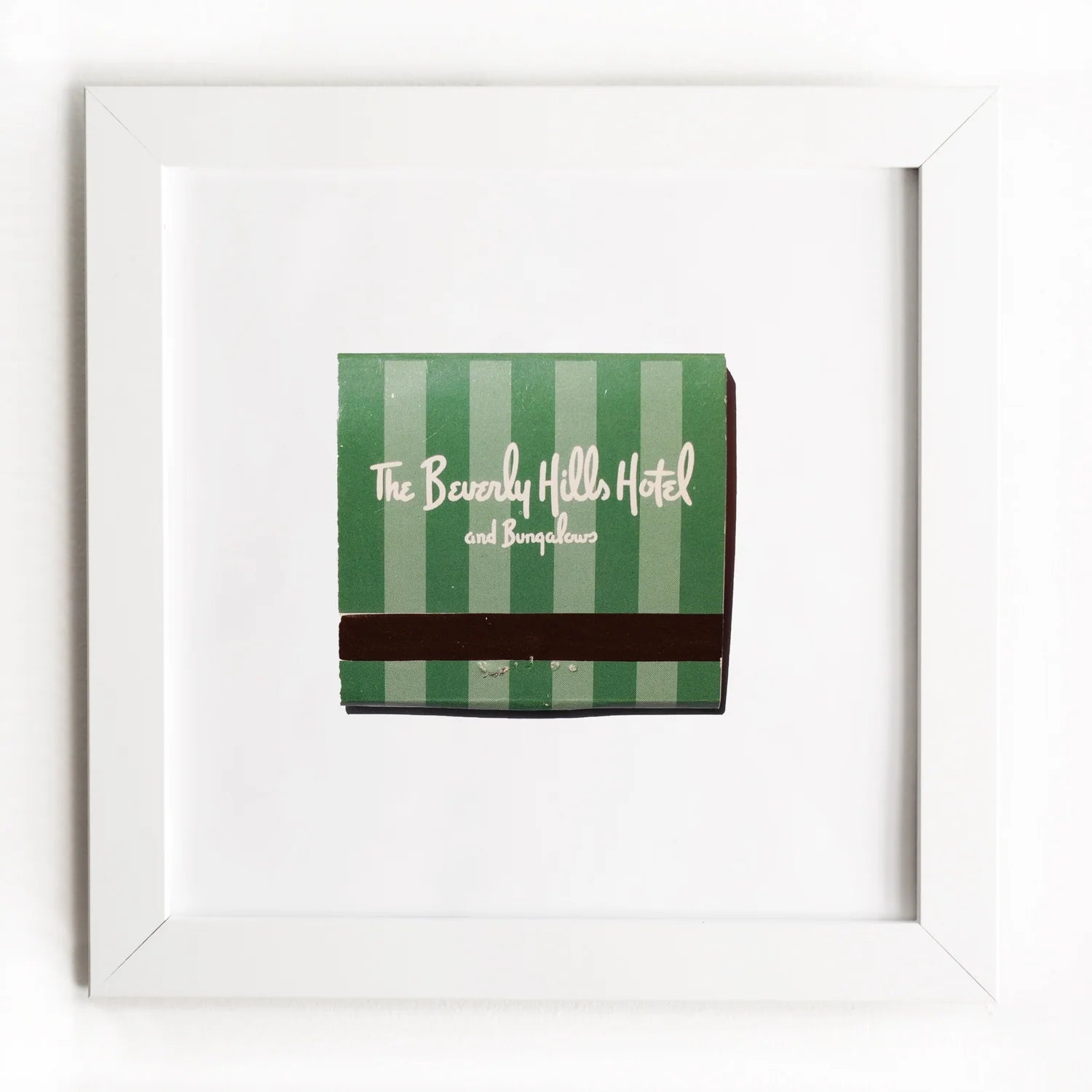An Art Square White Frame from Match South, featuring green and white stripes with brown accents, is displayed in a simple white frame against a white background.