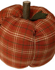 The Faire Pumpkin is an autumn ornament shaped like a pumpkin, featuring red plaid fabric, a brown stem, and a green felt leaf—ideal for cozy farmhouse decor.