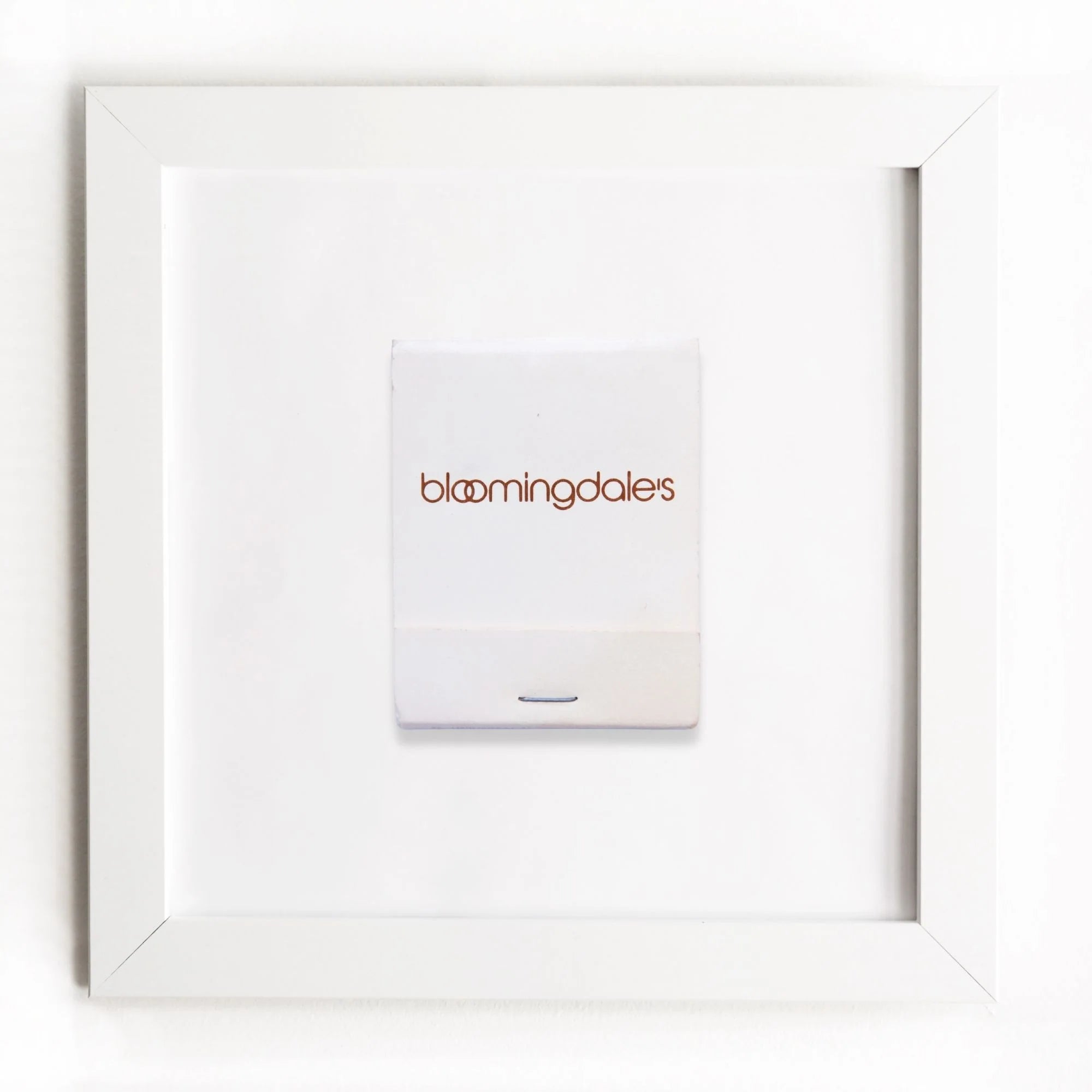 A Match South Art Square White Frame, predominantly white with the store's logo printed in lowercase, is centered within a simple, square white frame on a plain white background, evoking a minimalist bungalow style.