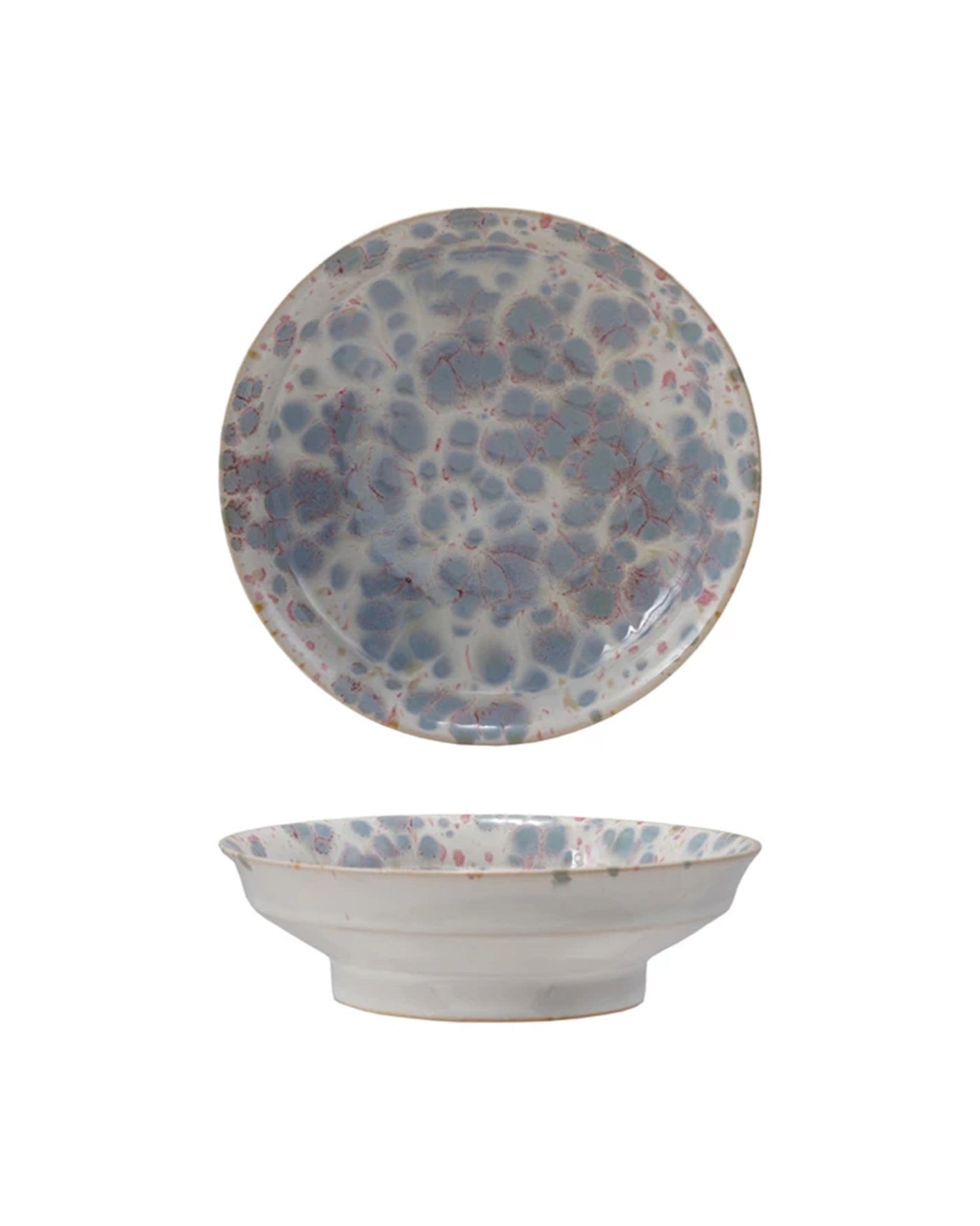 The Bloomingville Stoneware Footed Bowl features a shallow, wide shape with a reactive blue and pink glaze on white. Shown from top and side views against a white background.