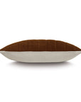 The Rufus Nubuck Leather Pillow by Eastern Accents is shown from the side against a white background, featuring a brown suede-like top, light beige fabric bottom, and subtle channeled detail.