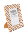 The BIDK Home 5x7 Bone/Wood Frame features a light and dark checkered design, stands upright on a beige support, and is ideal for home décor. It displays a placeholder image with "BIDK Home" and photo size 5"x7" (13x18cm).