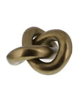 The Infinity Knot / Brass by HomArt is a sculptural decor piece in solid brass with a smooth, twisted knot design and subtly weathered sheen—perfect as a modern bookshelf accessory. Photographed on a plain white background.
