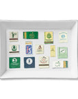 The Faire Ceramic Tray is a rectangular white ceramic tray featuring colorful matchbook cover illustrations from famous golf clubs—perfect for organizing small items or gifting to golf enthusiasts.