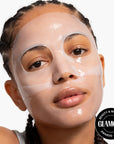A woman with braided hair wears a shiny Faire Loops/HydroGel Face Mask, looking neutrally at the camera. A "Glamour Beauty & Wellness Awards 2024" badge appears in the bottom right corner.