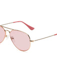 The Caddis Mabuhay Polished Gold aviator sunglasses feature pink-tinted lenses and matching rubber temple tips, shown on a white background.