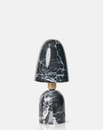 The Caswell Table Lamp by Abigail Ahern features a modern black design with a black and white marble finish base and shade, natural veining patterns, and a gold neck accent, set against a plain white background.