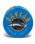 The Caviar Jewelry Case is a round blue velvet organizer with a yellow zipper, featuring an embroidered fish, "CAVIAR" in bold yellow letters above, and "PREMIUM QUALITY" in white below.