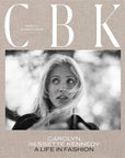 Black and white photo of a woman with windblown hair, framed by blurred branches. Text: “CBK: Carolyn Bessette,” Hachette Book Group. A tribute to the timeless style of this enduring fashion icon.