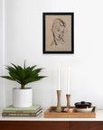 A minimal room includes a potted plant on books, two lit candles, a tray with a bowl, and "Haydon; Portrait study" by Faire—limited-edition art on matte paper in a simple frame displayed above.