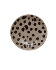 The Creative Co-op Dish with Animal Print features a round stoneware design with a beige base and black leopard spots. Displayed on a plain white background. Pair it with our bowls for a coordinated look. Dimensions available upon request.