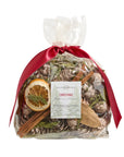 A clear bag of Faire Potpourri with pinecones, greenery, dried orange slice, and cinnamon sticks, tied with a red ribbon. Fill your home with classic holiday scents of balsam and pine this Christmas season. Label reads "Faire Potpourri.