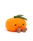 The Amuseables Clementine SM by Jelly Cat Inc. is a plush toy shaped like an orange, featuring a textured surface, green felt leaf, stitched smile, and corduroy legs—a charming festive gift ideal for Christmas stockings.