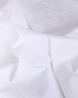 Twin cotton sateen sheet set with soft folds, smooth finish, and pom pom trim by Bungalow Furniture & Accessories.