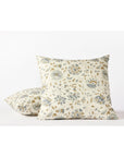 Two Coyuchi Inc Flora Org Print Sham Undyed Lagoon Euro shams—square, made of organic cotton percale, featuring a subtle botanical motif in blue, beige, and green on a white background. One sham stands upright; the other lies flat behind it.