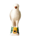 The Parrot Small by Blue Ocean Traders is a white ceramic bird figurine inspired by Jingdezhen hand-painted porcelain, standing upright on a yellow and green base with a small front hole, displayed against a plain white background.
