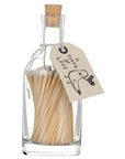 Faire's Glass Bottle Matches come in a plastic-free glass bottle sealed with a cork. A paper tag reading "A TOKEN OF LOVE" and a bird holding a heart makes them perfect for sustainable home décor.