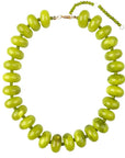 The Bailey Chunky Beaded Necklace by Faire showcases bold, glossy bright green marbled beads strung on a thin cord with an adjustable gold-tone clasp and bead chain at the back.
