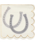 The Faire Cocktail Napkin is a stylish and fun white napkin featuring scalloped edges, two overlapping gray horseshoes, and a thin gold border that adds sophistication, making it perfect for any occasion.