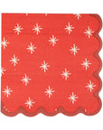 The My Mind's Eye Christmas Cocktail Napkin features a red design with white starburst patterns and a darker red scalloped border—ideal for adding festive flair to your holiday table decor.