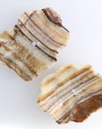 Two striped amber onyx/calcite mix slabs with earthy tones, Faire Bowl by Bungalow Furniture & Accessories.