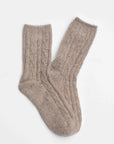 Faire Wool Speckled Knit Socks in beige feature a ribbed and cable-knit pattern, made from a wool-blend, and are shown laid flat on a white background.