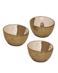 Three Dansbury Snack Bowls by Faire, featuring a textured gold exterior and smooth, glossy white interior, are arranged against a plain white background.