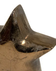 The Zentique Distressed Bronze Star - Small features a star shape with two prominent points and a reflective, slightly cracked surface, making it a striking accent for any home decor.