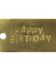 The HomArt Brass Tag is a hand-stamped rectangular brass tag with a left-side hole and "HAPPY BIRTHDAY" engraved in uppercase—perfect as a personalized gift or unique gift tag.