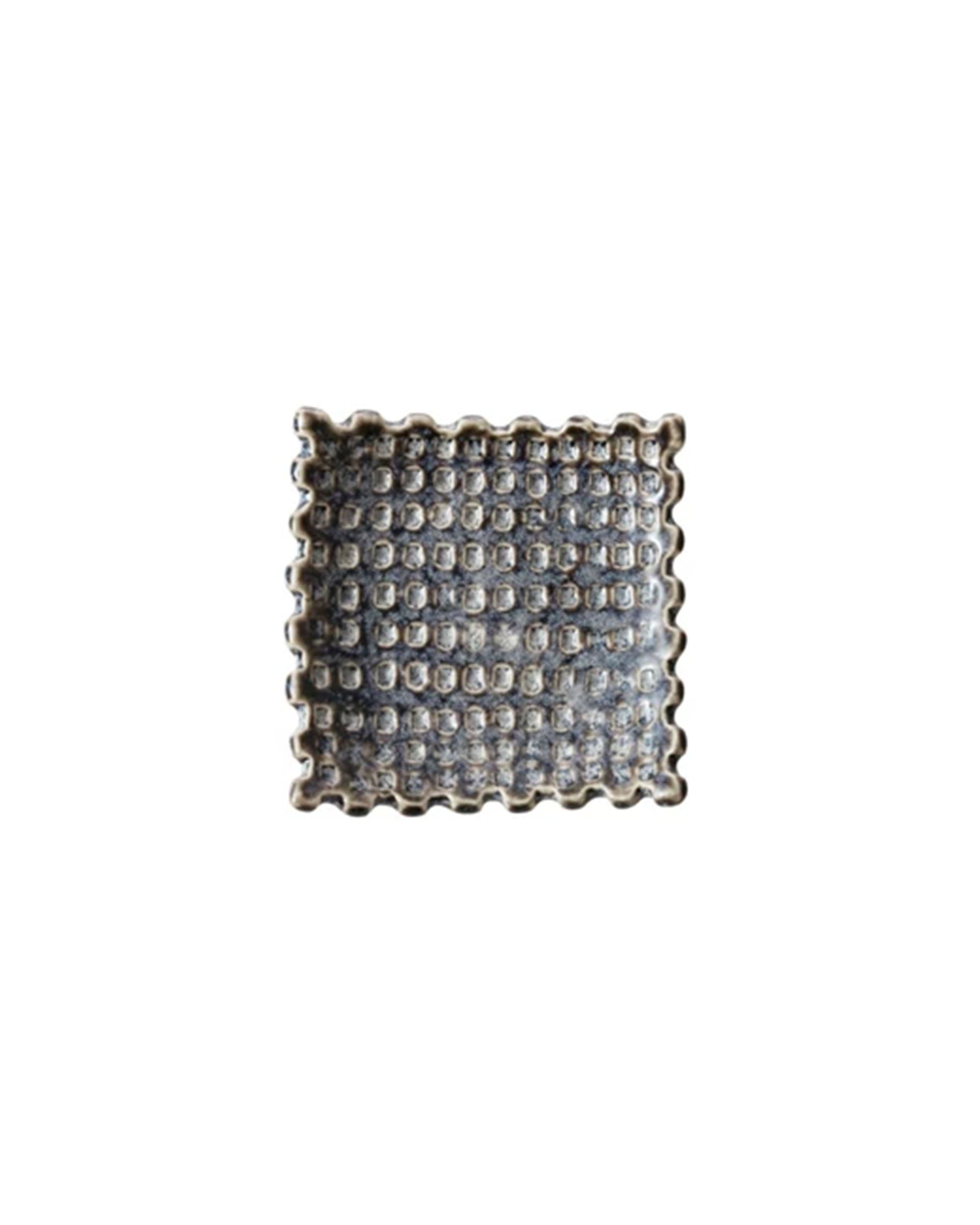 The Debossed Stoneware Dish by Bloomingville features a square, textured design with raised dots and scalloped edges, shown on a plain white background.